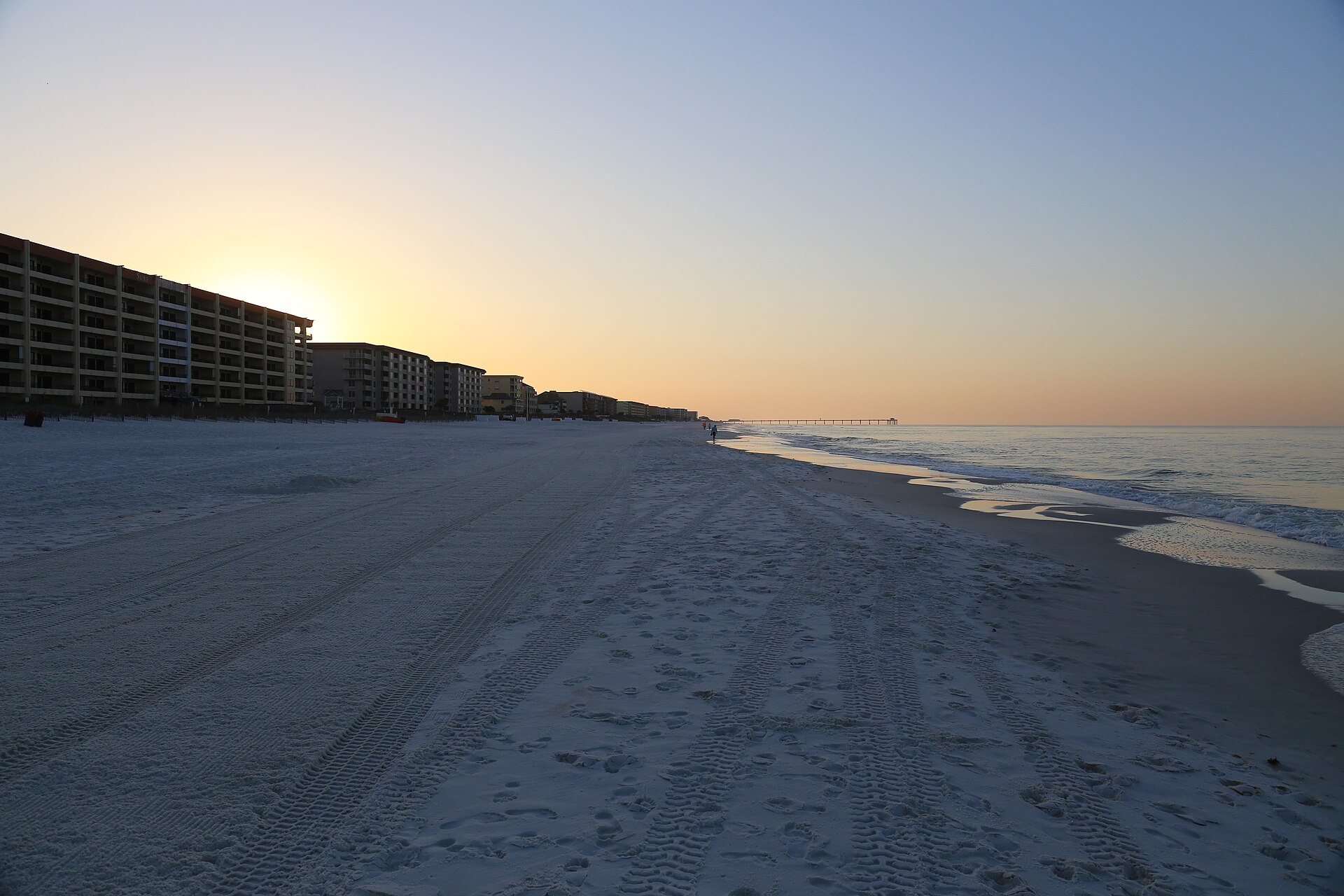 White-sand beach and pier at golden hour on Okaloosa Island, Florida